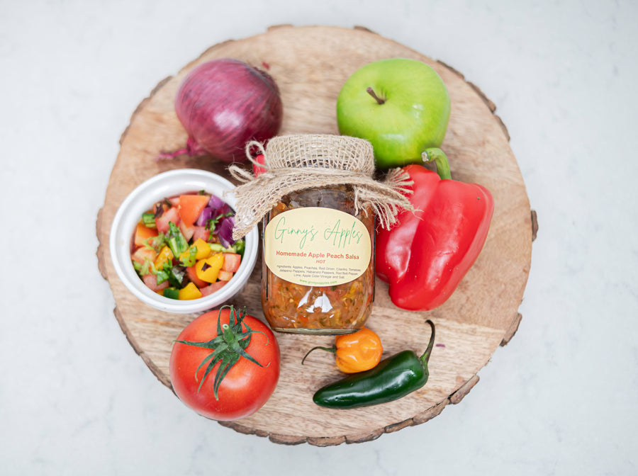 Ginny's Apple Peach Salsa with peppers, apples and tomatoes on a wooden board