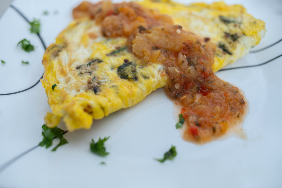 An omelet topped with Apple Peach Salsa